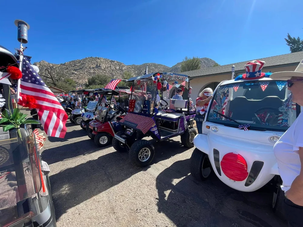 Two SDCE residents in a decorated golf cart enjoying the relaxed lifestyle of San Diego Country Estates